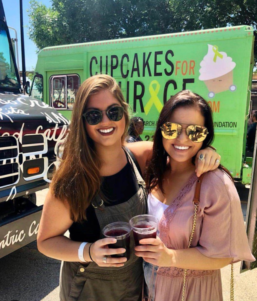 Vendor serving lines and shaded tent areas at the summer street fair