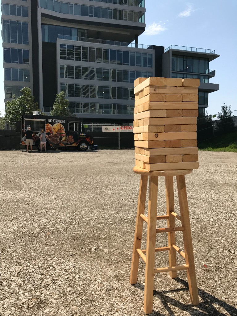 Giant Jenga and food truck with Chicago Food Truck banner at the South Loop festival