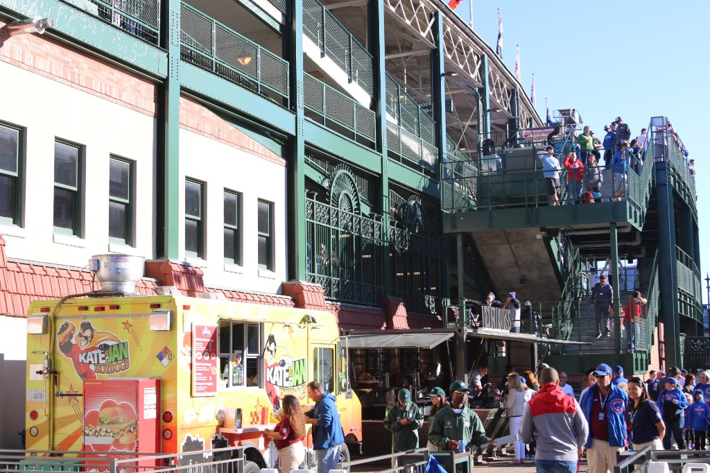 Gallagher Way plaza with fans walking toward Wrigley Field